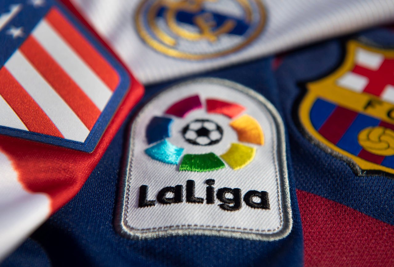 The La Liga logo with the Atlético Madrid, Real Madrid and FC Barcelona club badges on the first team home shirts on January 12, 2021 in Manchester...