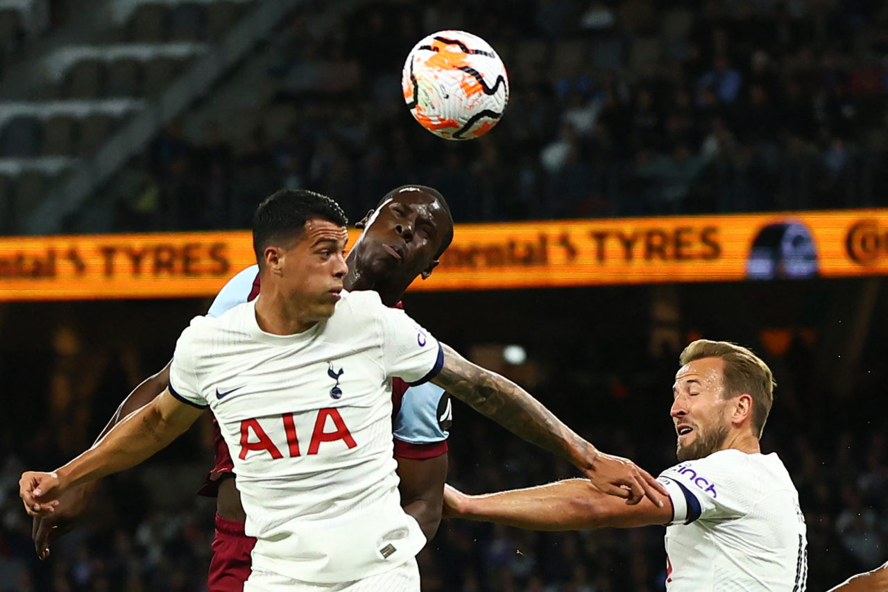 Kurt Zouma (C) of West Ham heads the ball next to Tottenham's Harry Kane (R) during an exhibition football match at Optus Stadium in Perth on July ...
