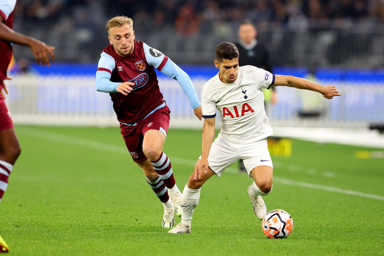 Manor Solomon of Tottenham runs down the field with the ball while under pressure from Jarrod Bowen of West Ham during the pre-season friendly matc...
