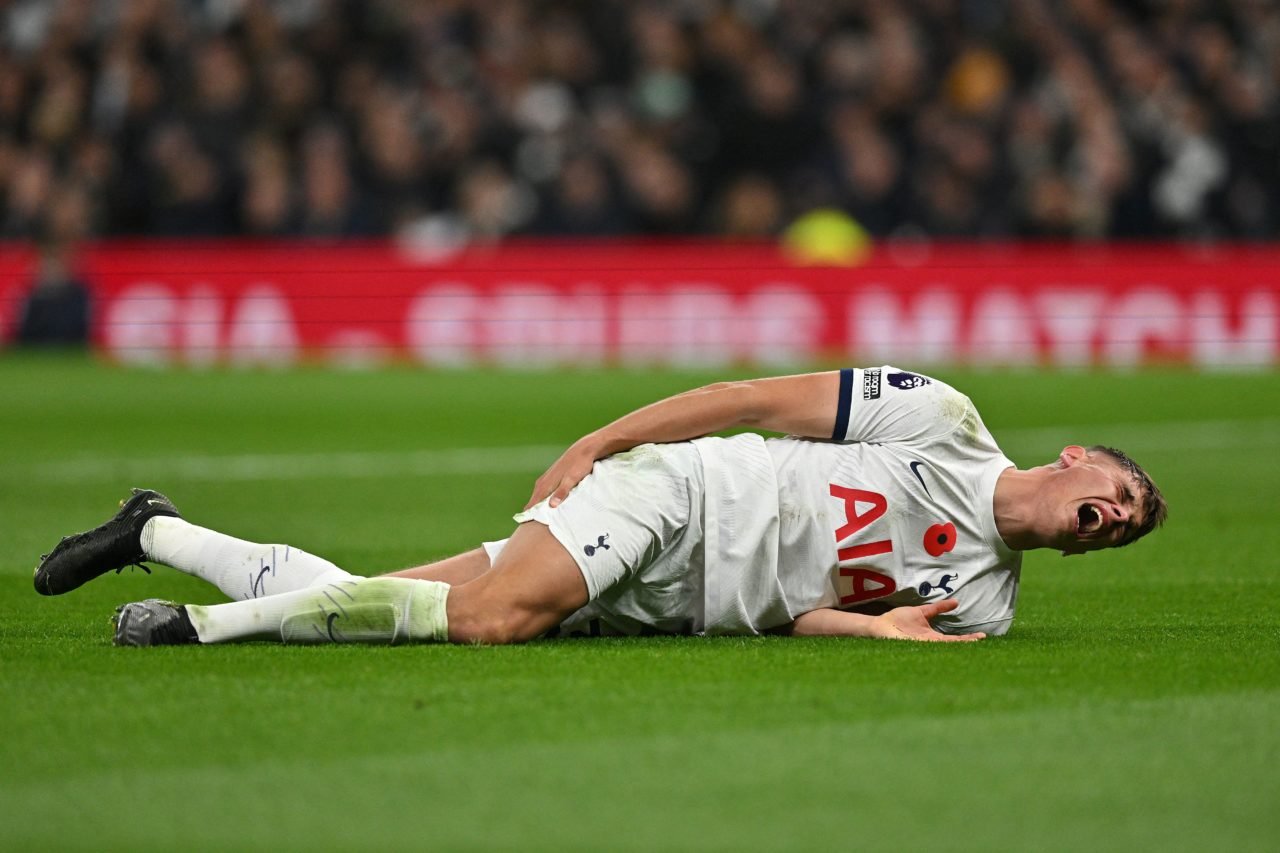 Tottenham Hotspur's Dutch defender #37 Micky van de Ven lays on the pitch injured during the English Premier League football match between Tottenha...