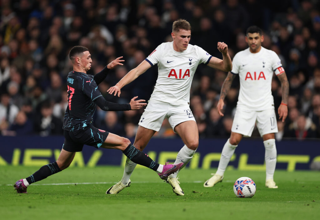Micky van de Ven of Tottenham Hotspur is challenged by Phil Foden of Manchester City during the Emirates FA Cup Fourth Round match between Tottenha...