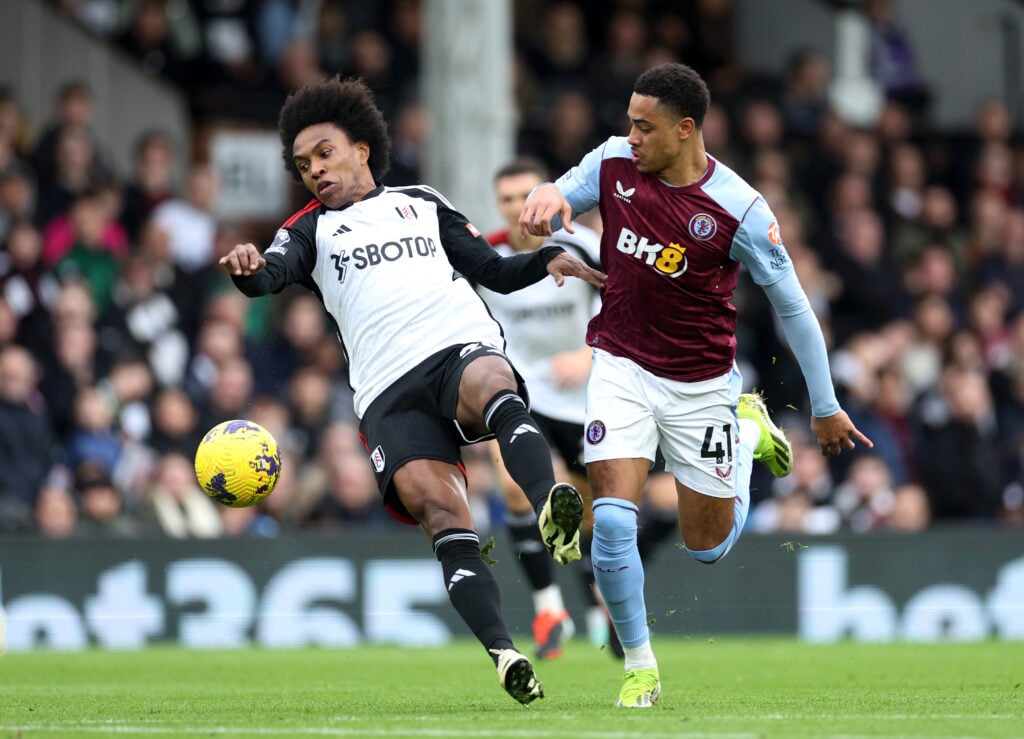 Willian of Fulham is challenged by Jacob Ramsey of Aston Villa during the Premier League match between Fulham FC and Aston Villa at Craven Cottage ...