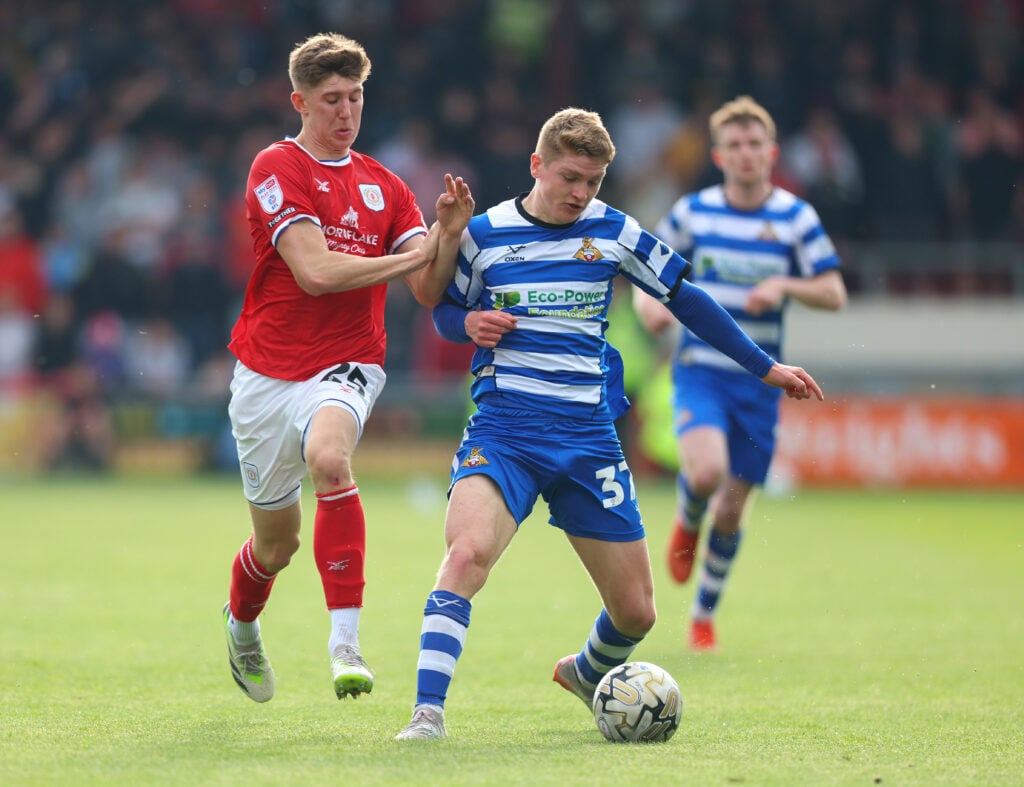 Matthew George Craig of Doncaster Rovers is challenged by Josh Austerfield of Crewe Alexandra during the Sky Bet League Two Play-Off Semi-Final 1st...