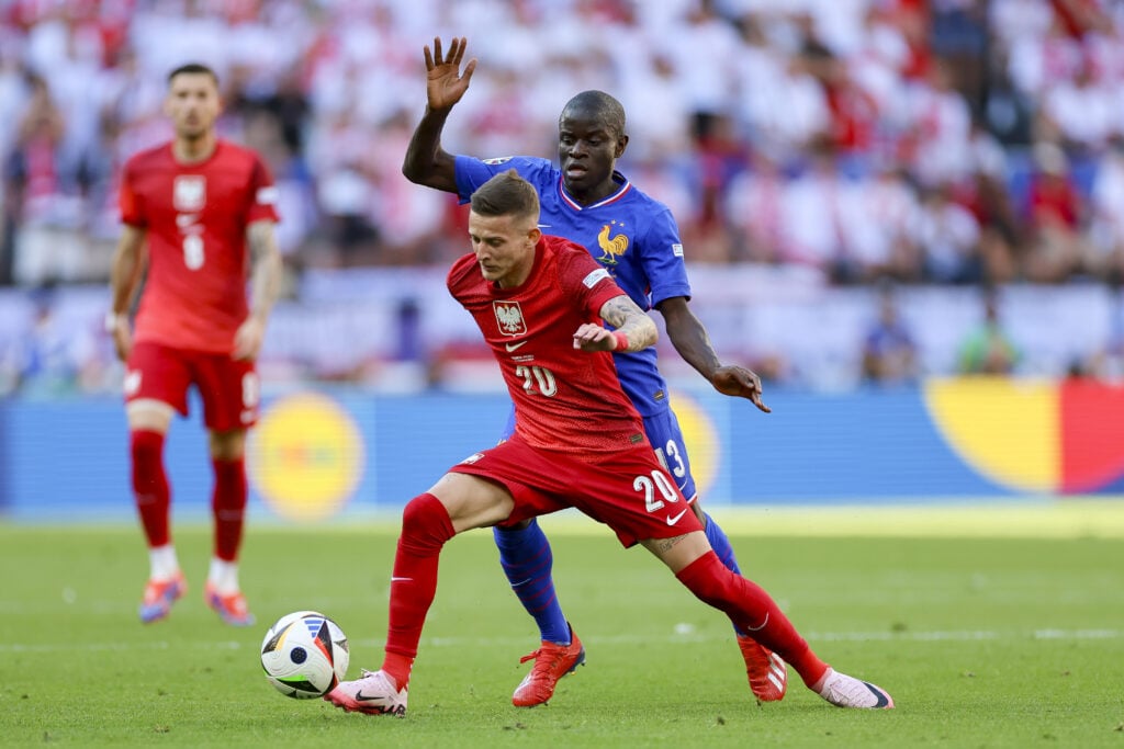 Sebastian Szymanski of Poland and Aurélien Tchouameni of France battle for the ball during the UEFA EURO 2024 group stage match between France and ...