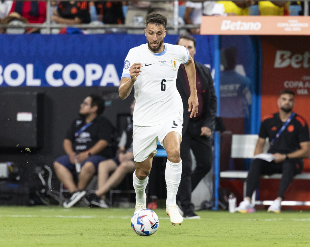 Rodrigo Bentancur #6 of Uruguay advances with the ball during the CONMEBOL Copa America 2024 semifinal match between Colombia and Uruguay at Bank o...