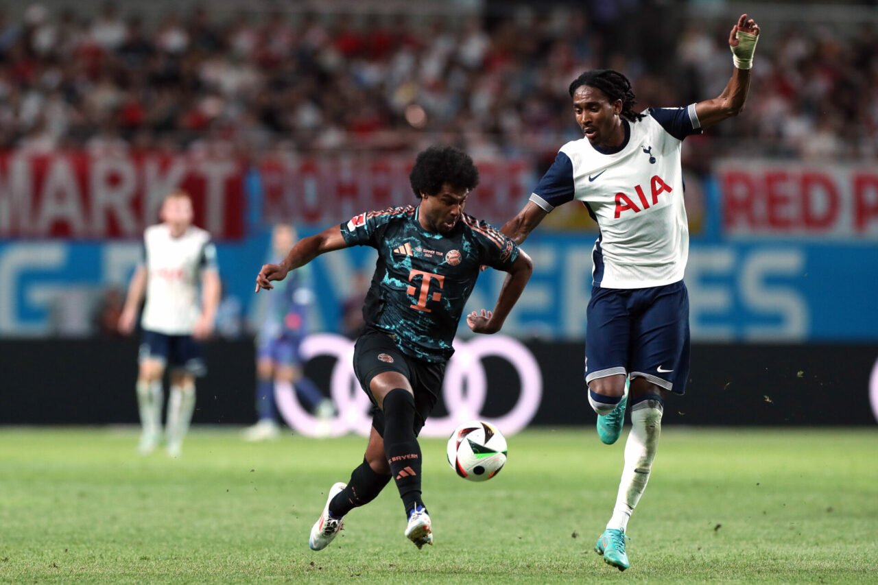 Serge Gnabry of Bayern Muenchen (L) controls the ball under pressure of Djed Spence of Tottenham Hotspur (R) during the pre-season friendly between...